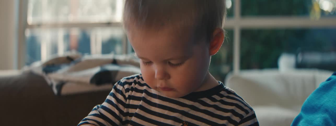 Little boy interacting with a speaker