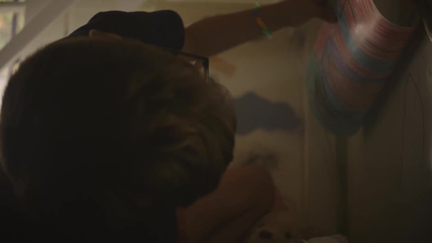 Boy looking at a cardboard with a drawing