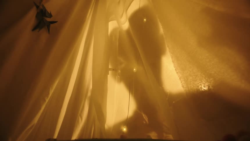 Shadow of a person against a sheet