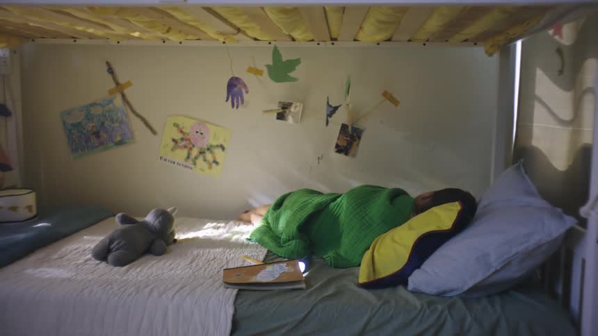 Child lying on a bunk bed in the bedroom sleeping