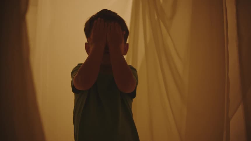A clip of a kid covering the face with his hands