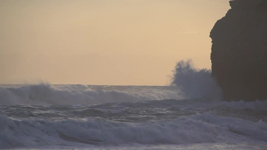 Waves crash onto a beach