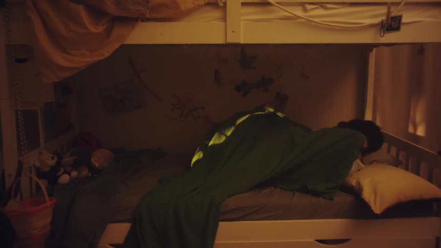 Two little boys lying down on the bed
