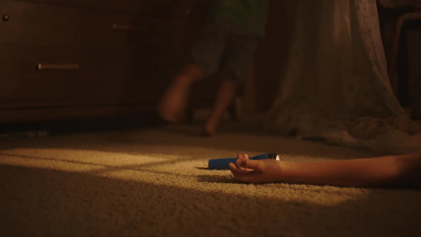 Lantern falling to the ground with a persons arm and a child running in the background