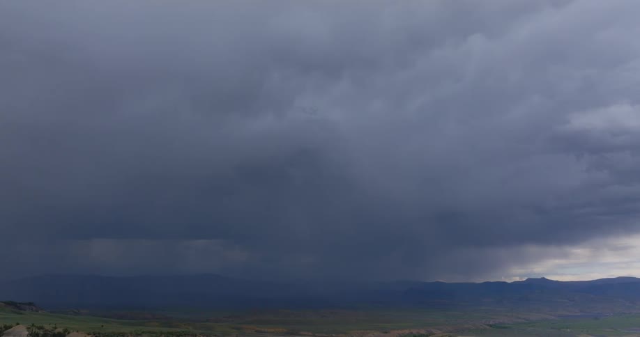 Storm clouds gathering in the sky over a plain