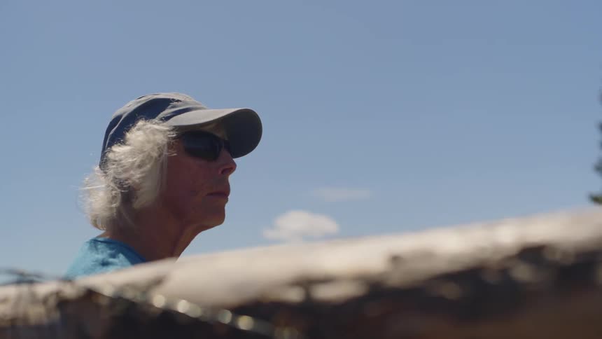 Woman in sunglasses in an outdoor setting on a sunny day