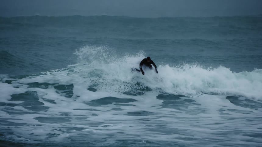 Surfer doing a trick on a wave