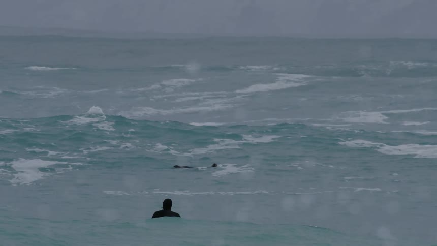 Two surfers in the middle of the ocean