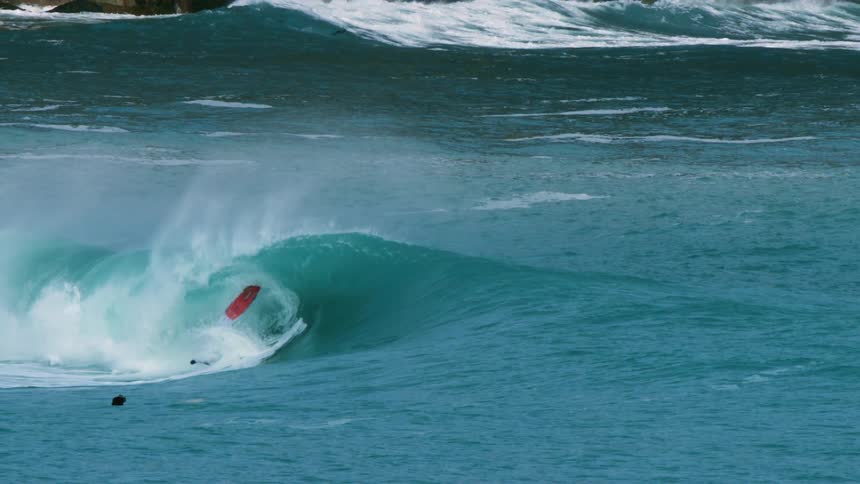 Person surfing a wave and ends up falling