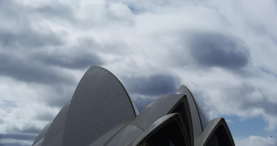 Sydney opera house peaks under cloudy sky