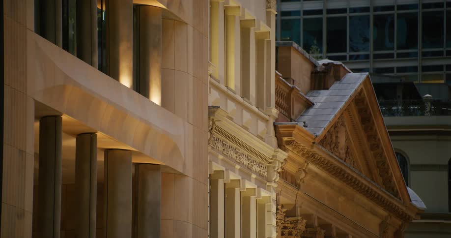 Building with classical architecture illuminated by the city