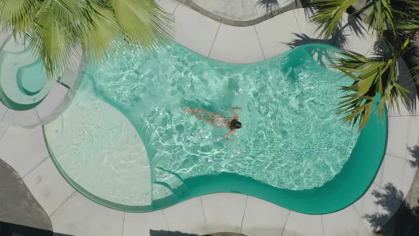 A woman swims in a pool