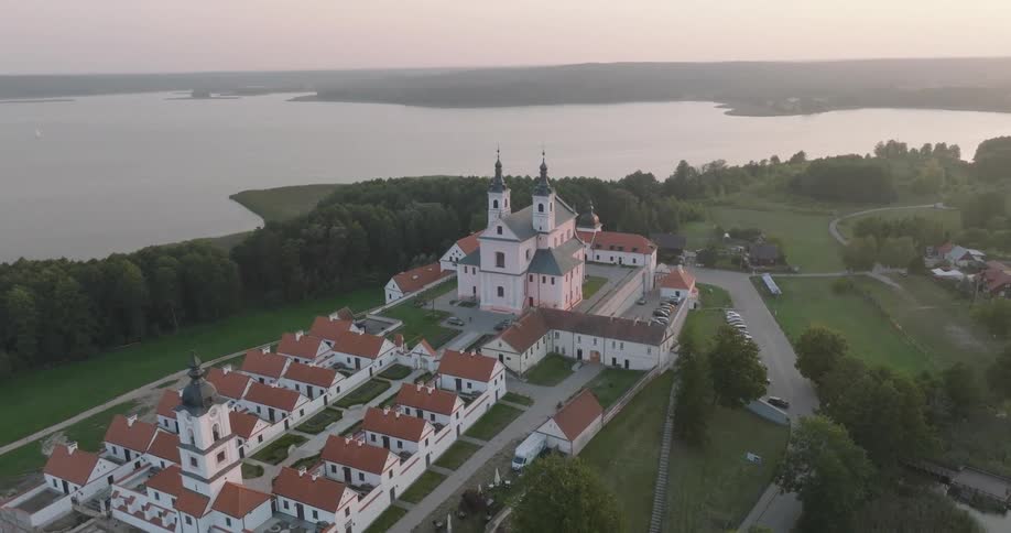 A large religious compound with a church and outer buildings sits on a promontory on a coast