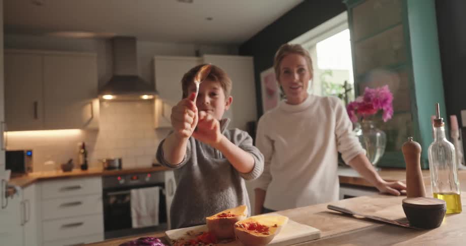 Mother and son playing in the kitchen