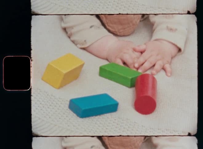 Unrecognisable baby girl crawling towards colorful retro wooden toy blocks on the carpet trying to reach the toys that are laying in front of her on the ground while learning new things with a playful approach
