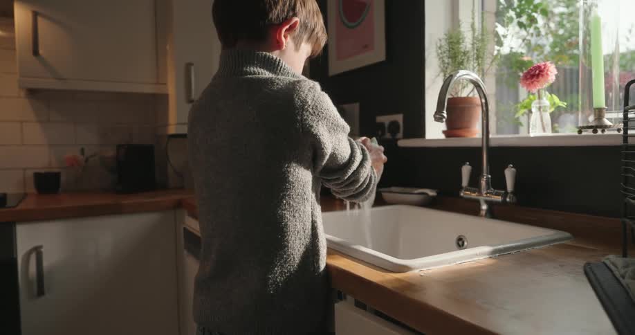 Boy washing dishes