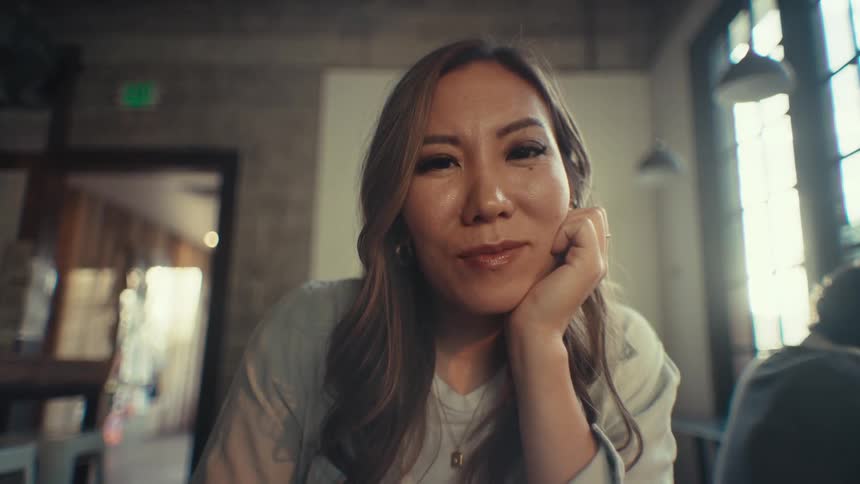 Portrait of a young woman sitting and looking at the camera