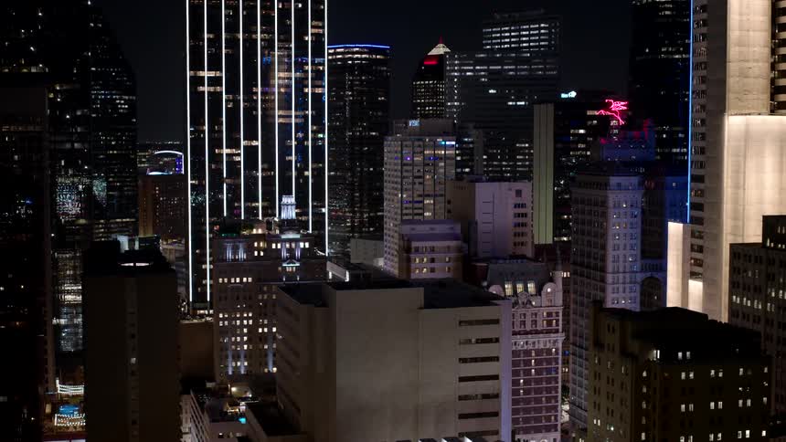 Night cityscape with several illuminated buildings against the dark sky