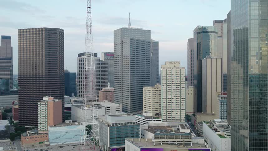 A metropolitan city center with several large commercial buildings and their exteriors with reflective windows