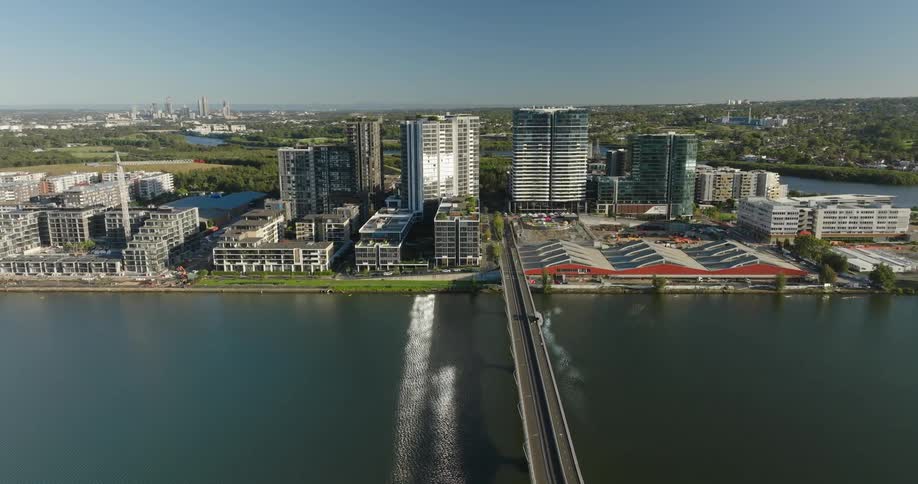 A bridge crosses a river into a downtown area of a city that sits on a promontory