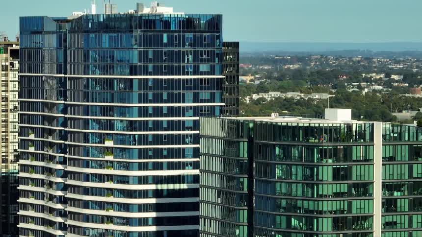 A closeup view of modern highrise buildings with reflective glass facades
