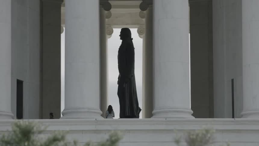 Statue framed by large columns