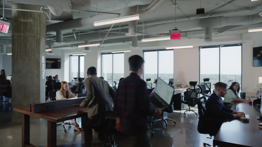 Workers walking and sitting in an office room