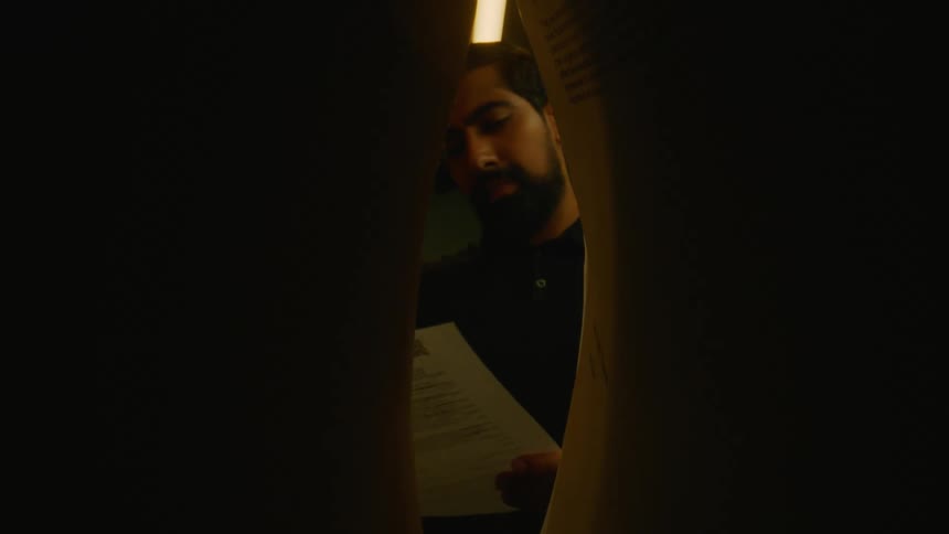 Man taking a document out of a folder