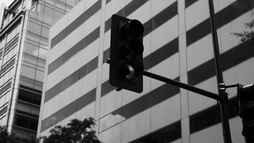 Traffic light in a metropolis with large buildings around