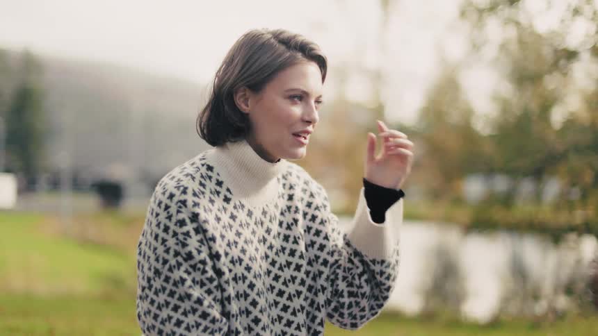 Woman sitting on the grass talking to another person