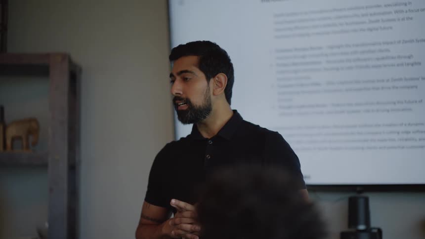 Man giving a presentation talks with his coworkers during a meeting