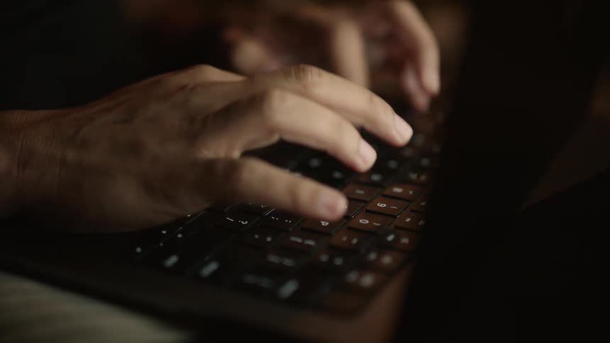 Close up of a hand typing on a laptop