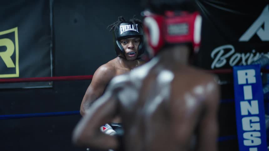 Two young teenagers fighting in a sweaty body training in a boxing ring