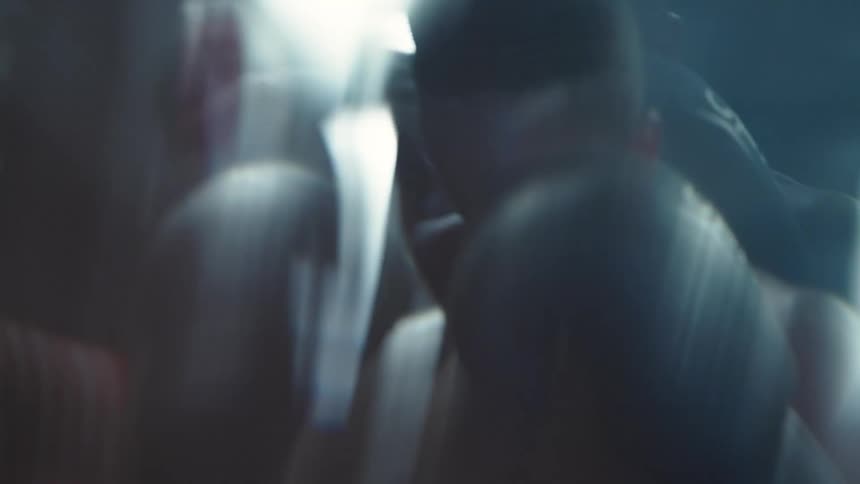 Man with boxing gloves punching a punching bag
