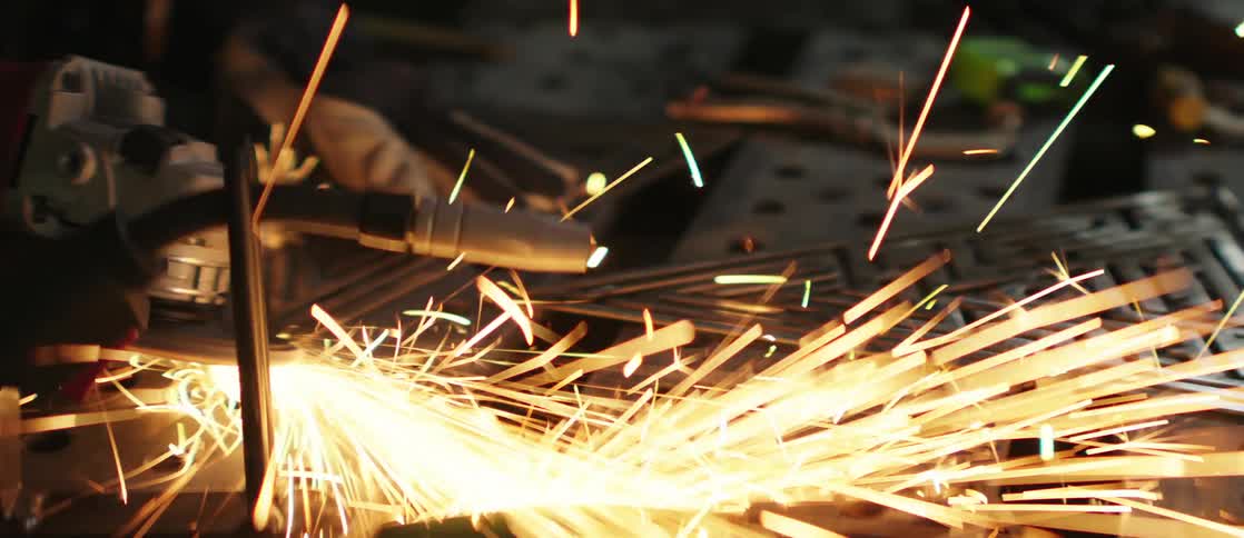 Sparks fly as a tool welds metal