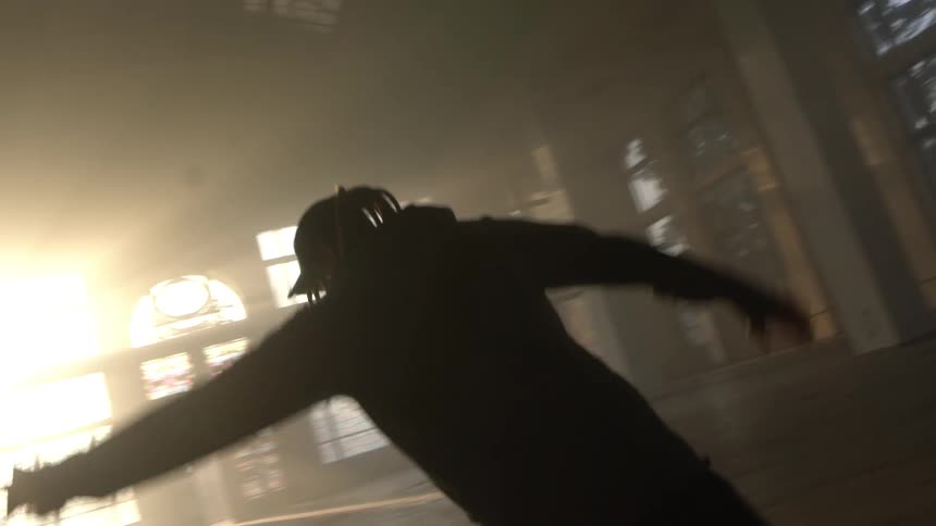Man alone in a room dancing and doing a backflip