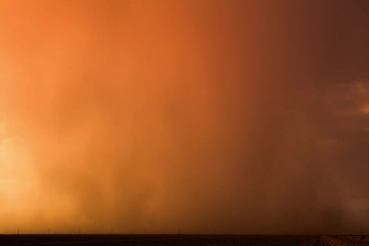 Scenery with rainy storm in a reddish sky
