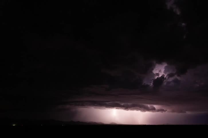 Lightning storm moves across the rural countryside at night