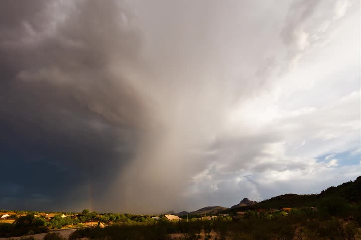 Time lapse of a gust of rain falling over a flat landscape