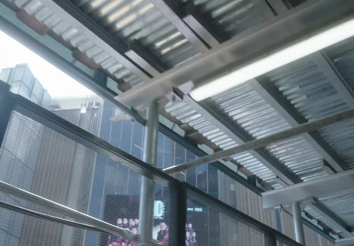 Point of view as someone walks underneath scaffolding across from Madison Square Garden