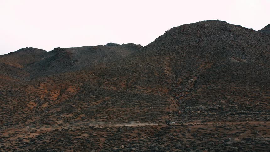 A rocky mountainside with sparse vegetation