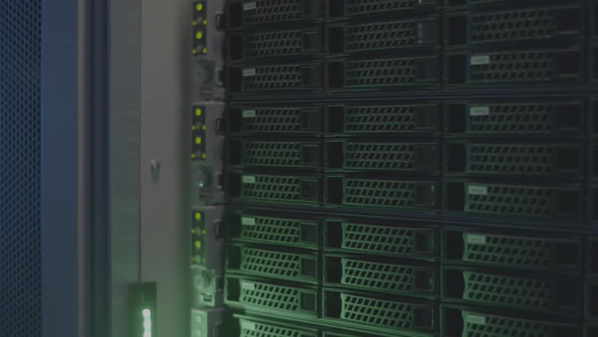 A server rack with multiple compartments and blinking green lights
