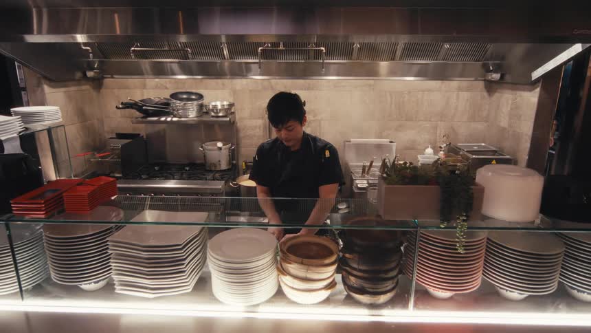 Chef in a restaurant kitchen chopping vegetables