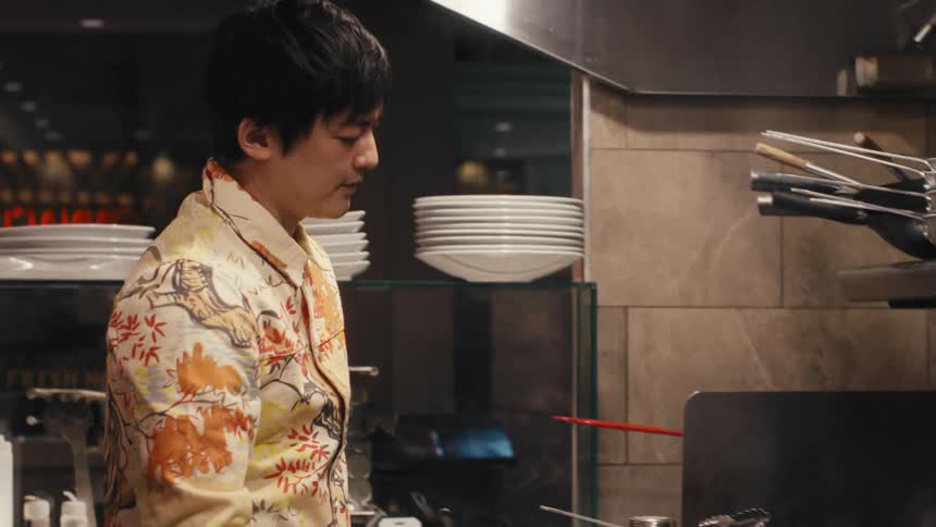 Male Chef turning off the stove in a restaurant kitchen