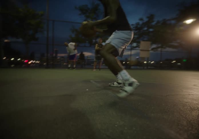 Two men are playing basketball in the city