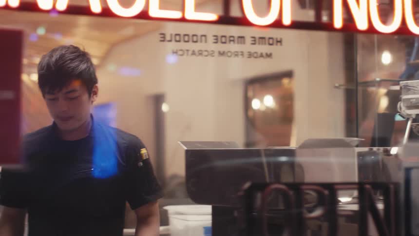 Restaurant worker walking through kitchen