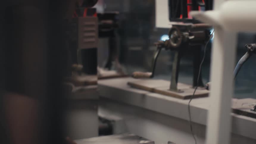 Restaurant worker using machinery in kitchen