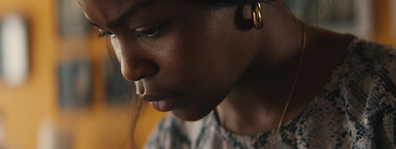 Side portrait of a young woman looking down concentrated