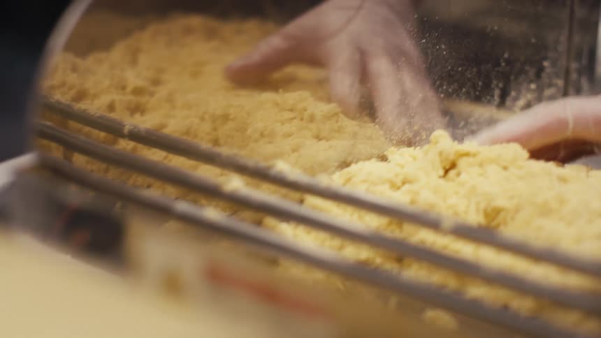 Hands with gloves preparing a dough