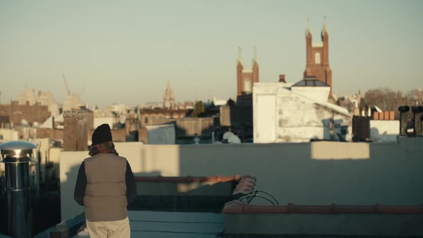 Person walks on a rooftop on a cloudy day